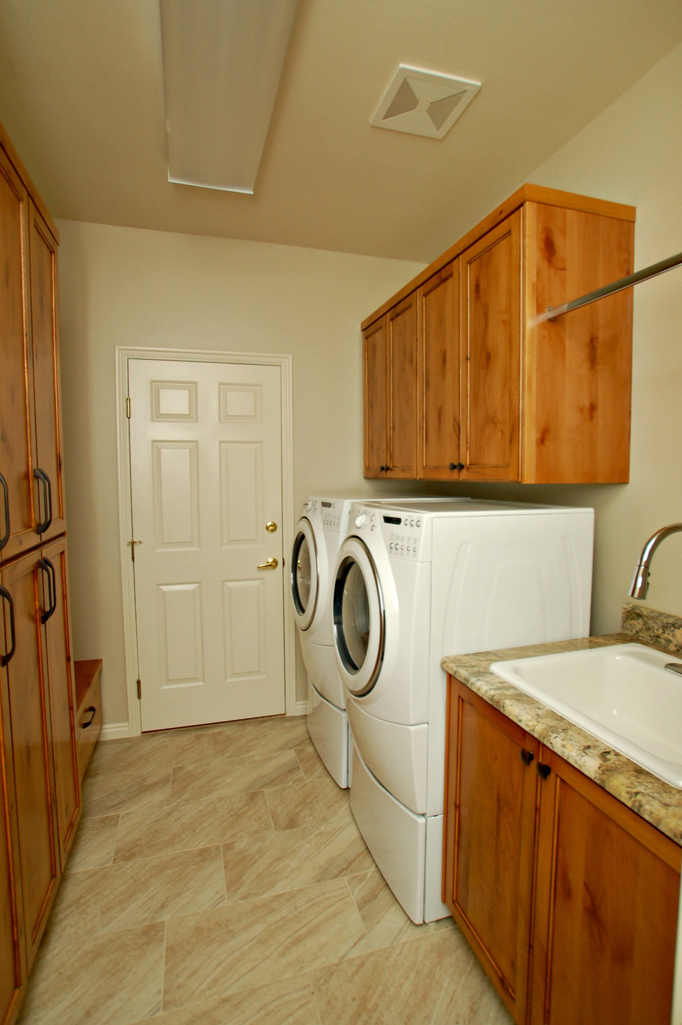 Laundry room with new cabinets, bench and storage
